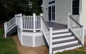 grey azek compoiste pvc custom decking with 2 stairs white vinyl rails and lattice