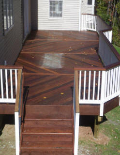 ipe deck with herringbone decking pattern white vinyl rails