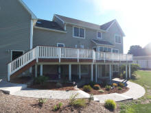 taller ipe deck with white vinyl rails and landscaping