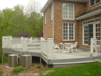 large ipe deck in avon ct with king posts and vinyl rails before