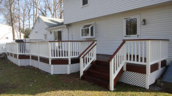 ipe deck specialists inc deck with white vinyl rails and white lattice after