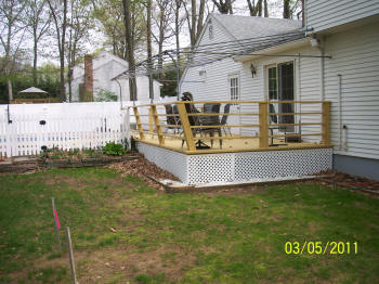 ipe deck specialists inc deck with white vinyl rails and white lattice after