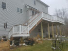 elevated custom Ipe ironwood decking with stair landing white pvc fascia vinyl rails